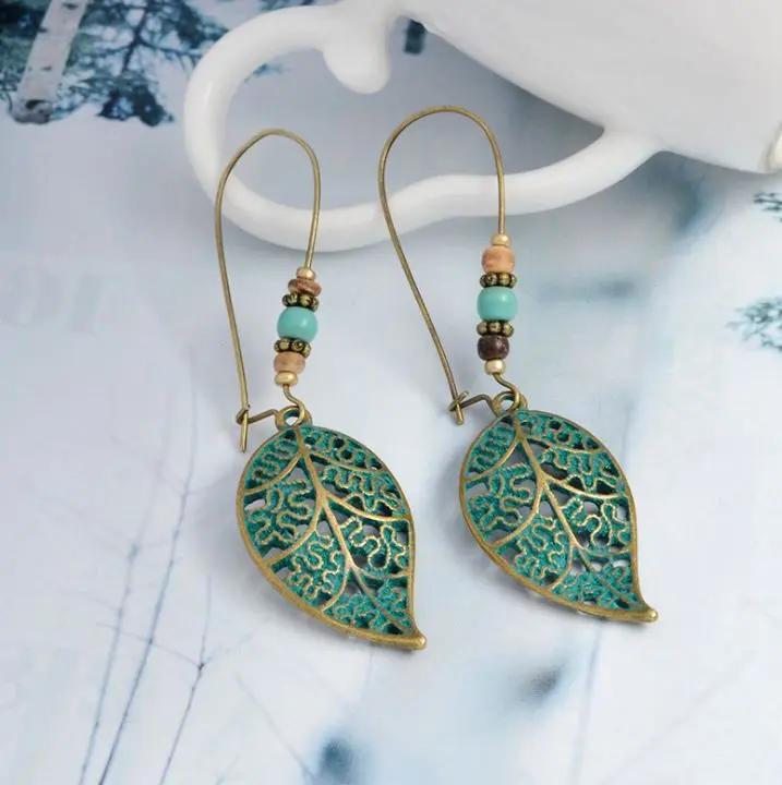 

New Exaggerated Retro Stud Earrings Hollow Leaf Bead Pendant Earrings