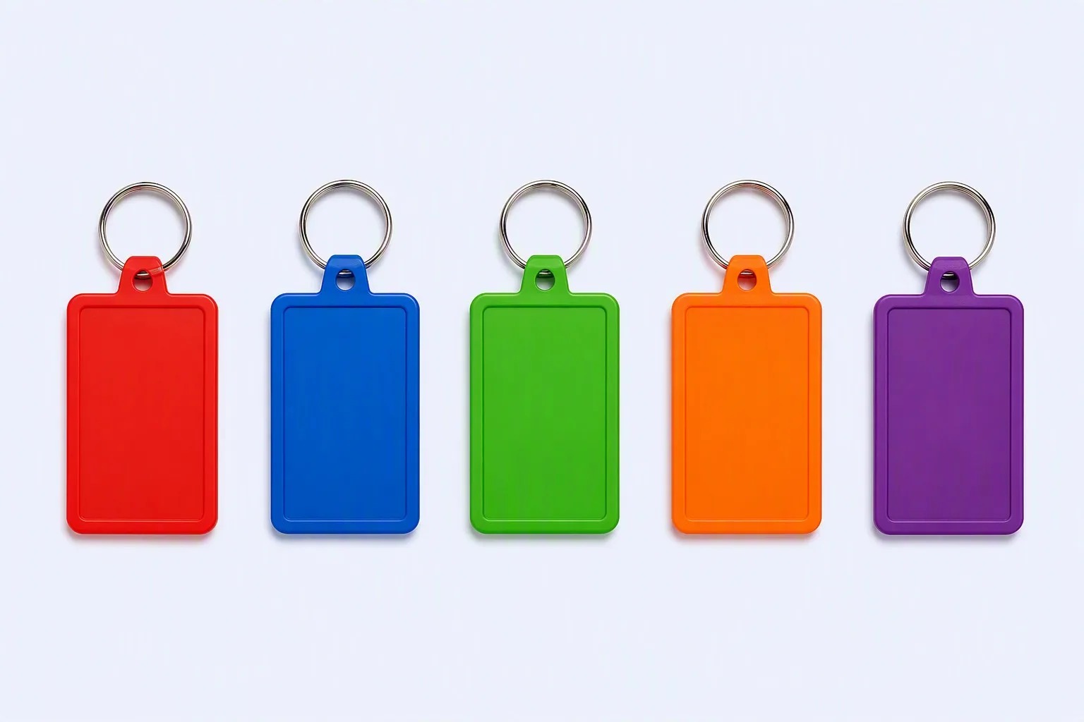 PVC keychain two-tone navy-red triangular design lying on clean surface