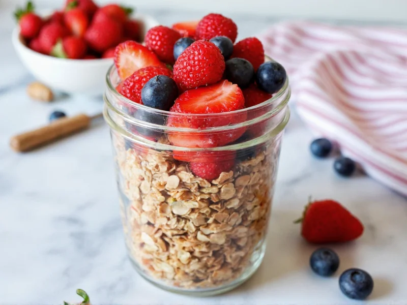 Homemade healthy granola in mason jar with fresh berries