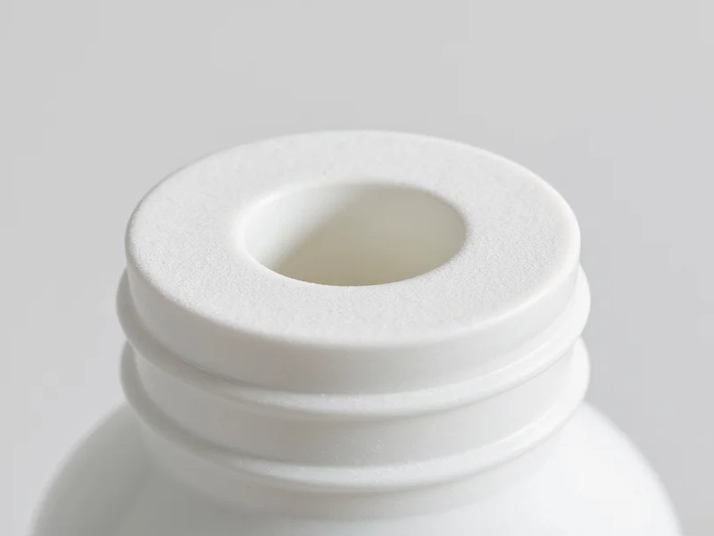 Close-up of sanded plastic bottle feeder edges showing smooth finish