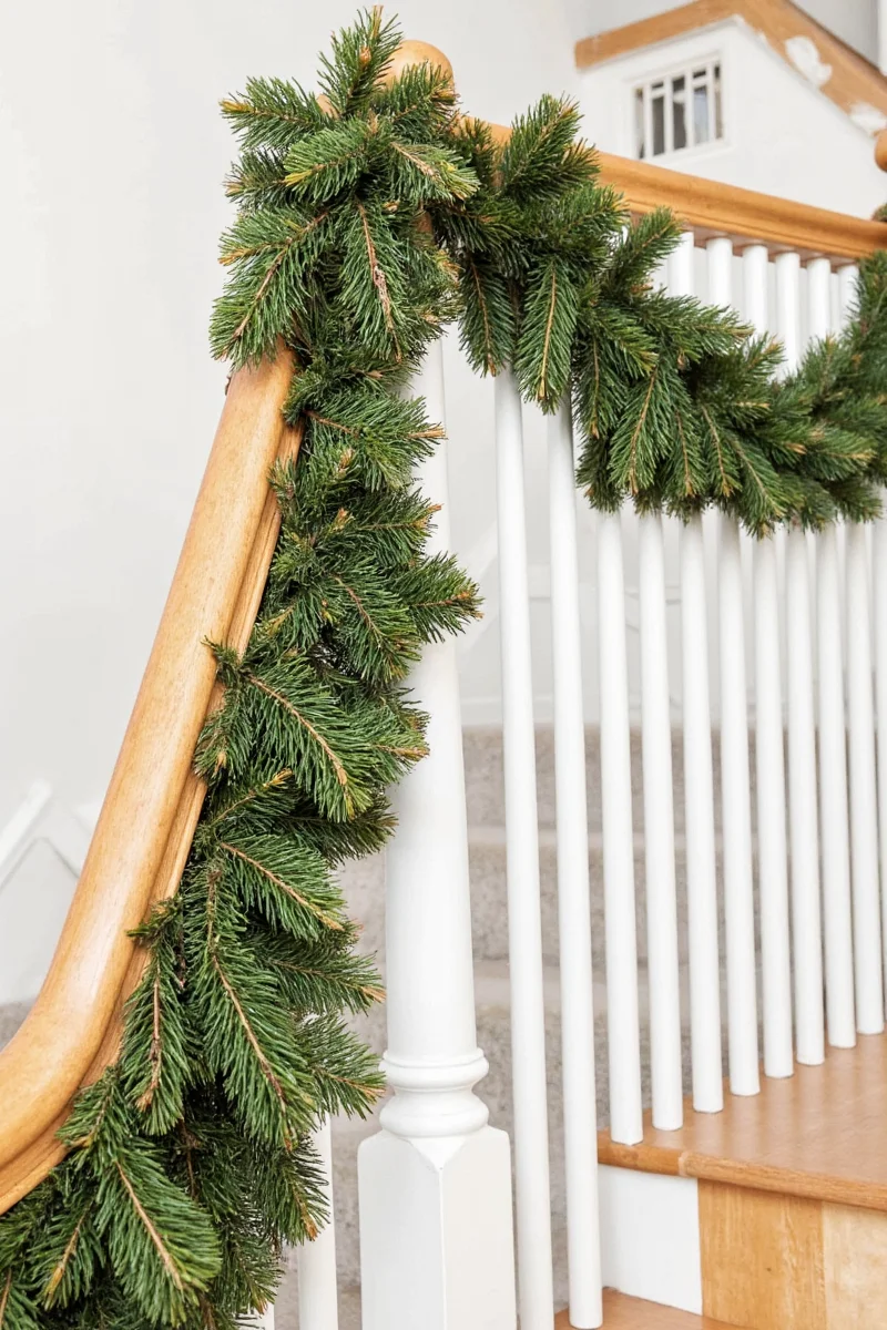how to drape garland on a banister like a pro without looking like santa s elf fell off the ladder
