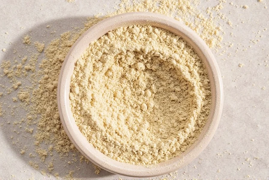Garlic powder next to fresh garlic cloves