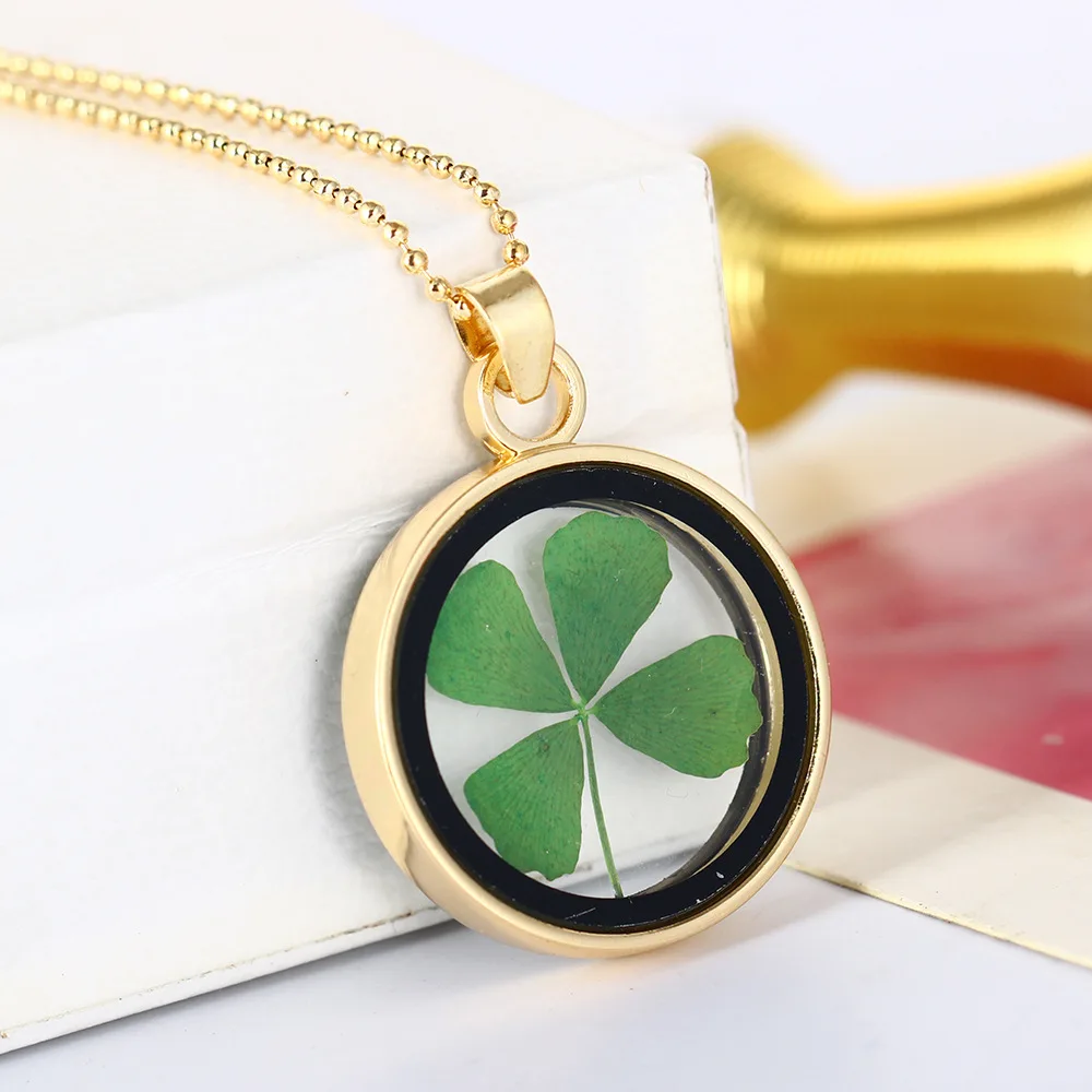 

Four-leaf clover plant glass specimen necklace, real flower and dried flower gold sweater chain female pendant