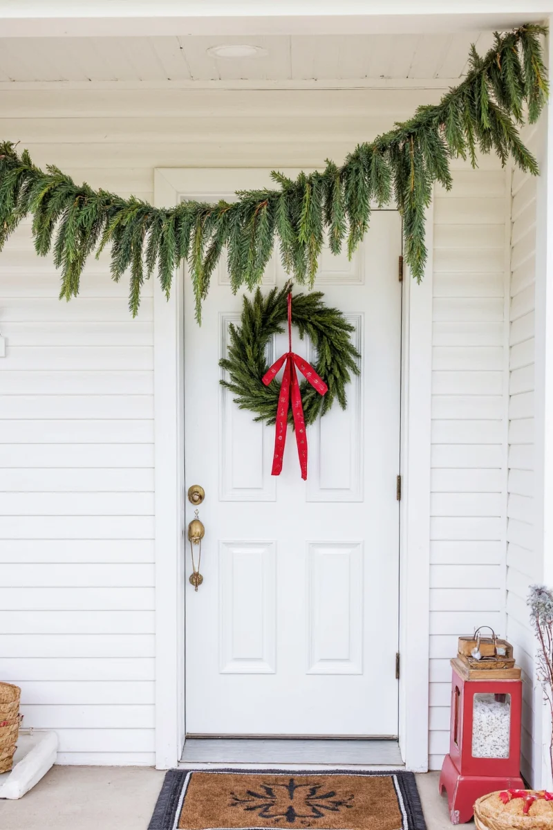 Family working together to decorate door with garland