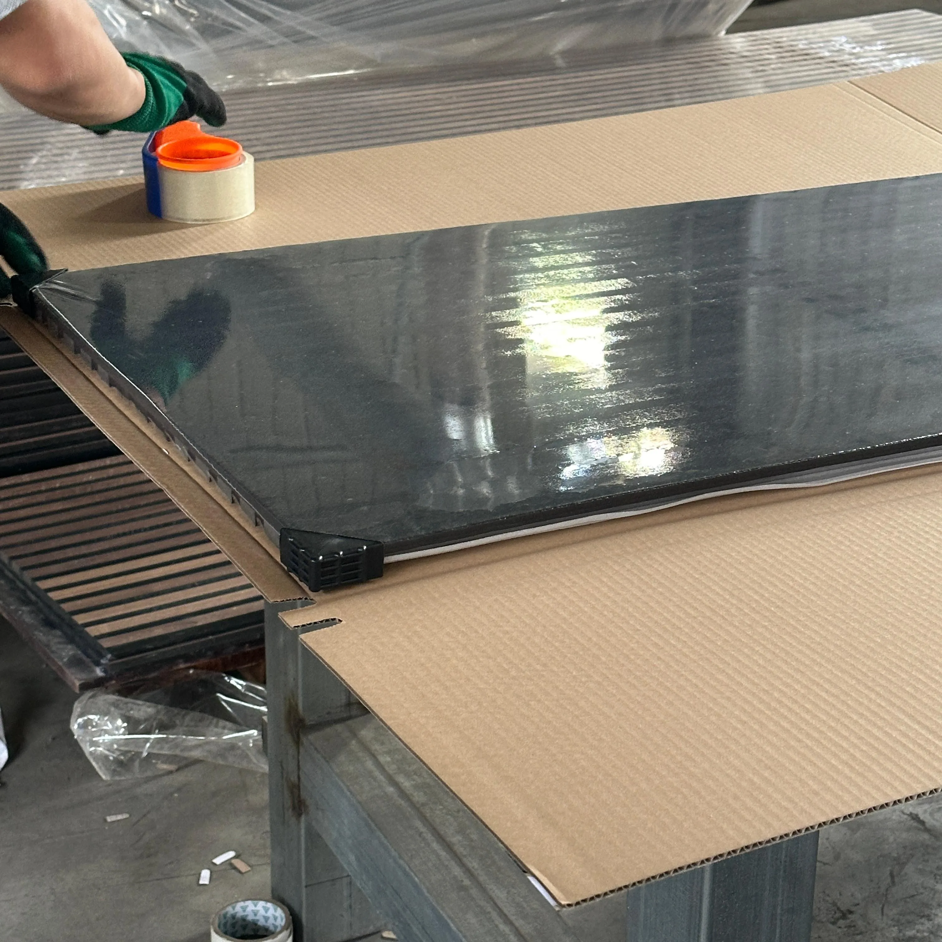 Acoustic panels individually film-wrapped with corner protectors and foam liner before shipment