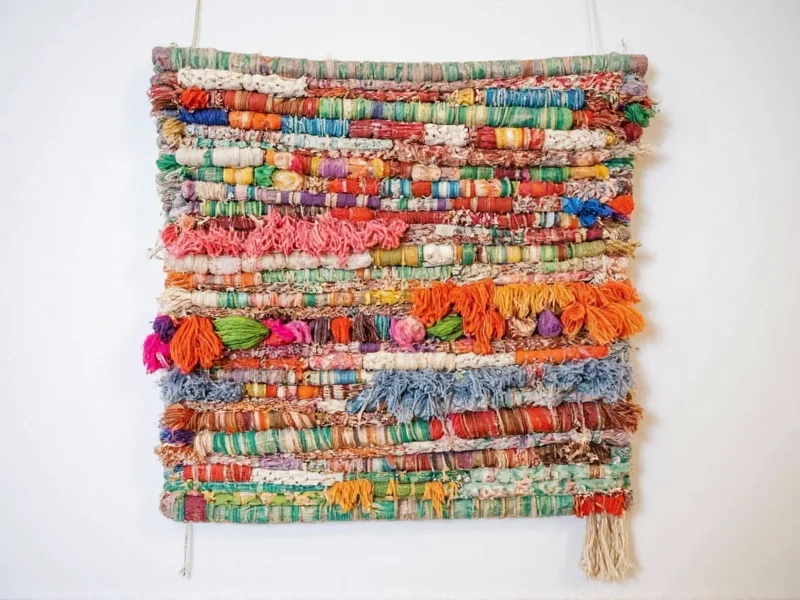 Colorful woven wall hanging made from recycled fabric