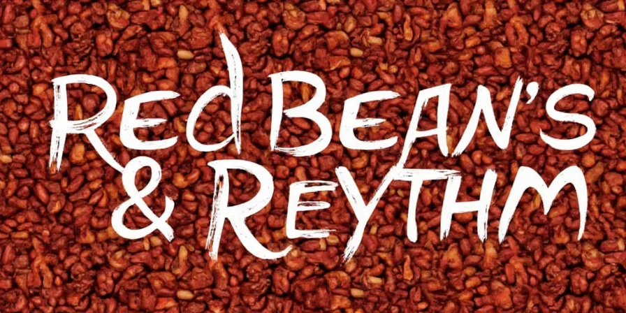 A steaming bowl of red beans garnished with fresh herbs and lime wedge