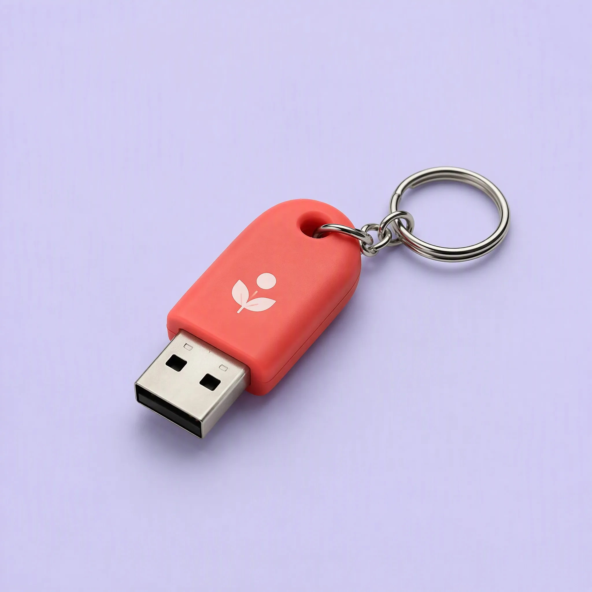 Studio Flat-Lay View of Coral Red Mini Silicone Capsule USB Drive with Sprout Graphic and Stainless Steel Split Keyring