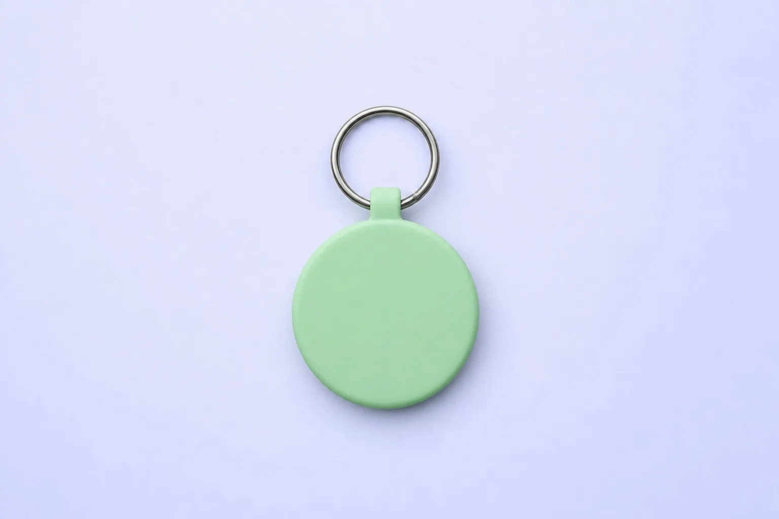 Single mint green keychain tag on a lavender background