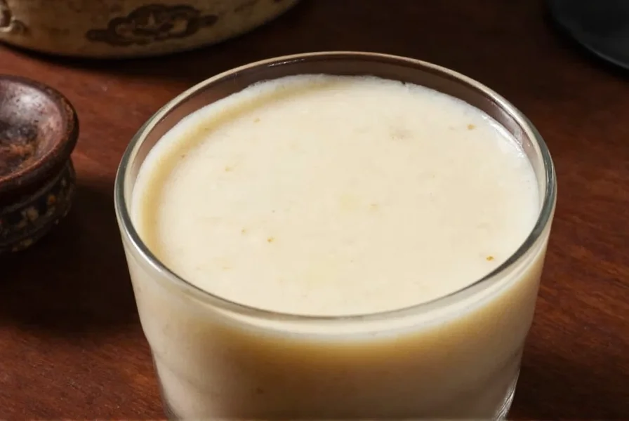 Traditional Cantonese ginger milk dessert served in small porcelain bowls with fresh ginger root
