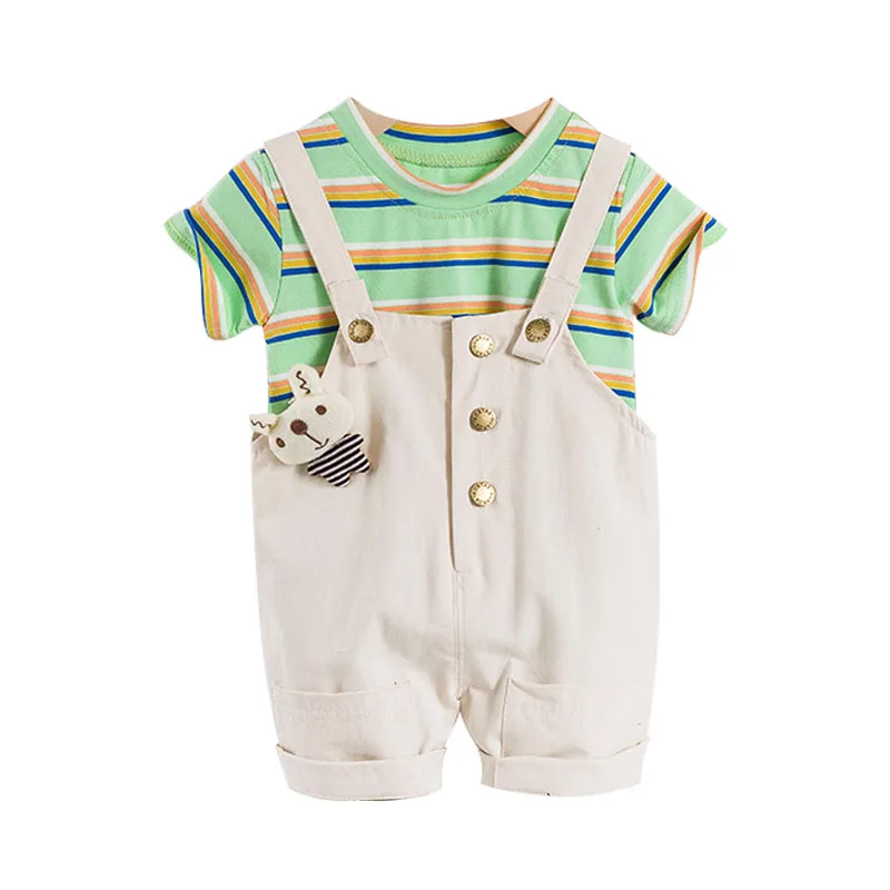 

A round-neck striped knitted fabric T-shirt and beige suspender shorts for a toddler girl in 2021. Children's suit for children, Picture