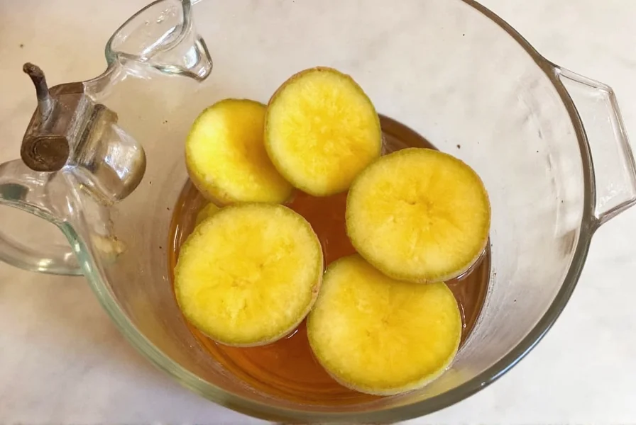 Homemade ginger tea preparation with fresh ginger slices in a teapot
