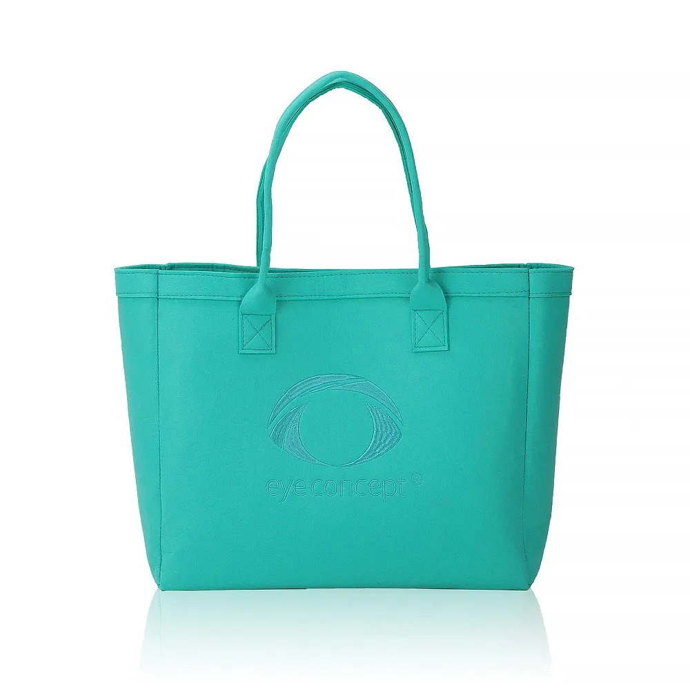 Teal structured tote bag with a debossed eye-shaped logo and wordmark pressed into the front panel