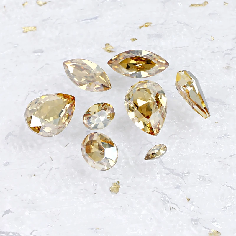 

Wholesale Nail rhinestones Pointback Fancy Stones Golden Light in different shapes For Nail Art