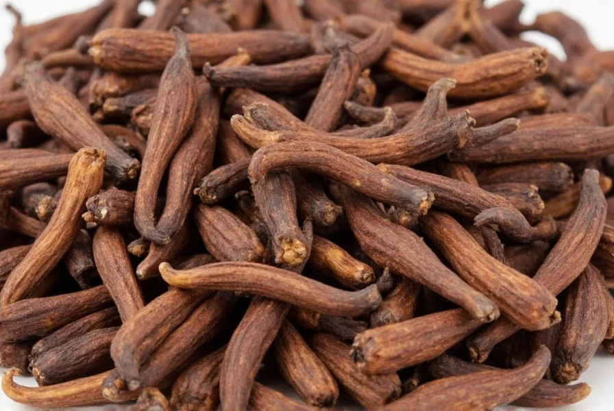 Chef slicing fresh cloves for culinary preparation