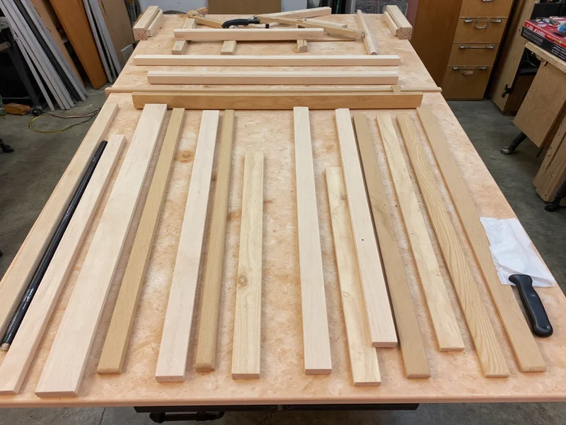 DIY Murphy bed kit components laid out on workshop table