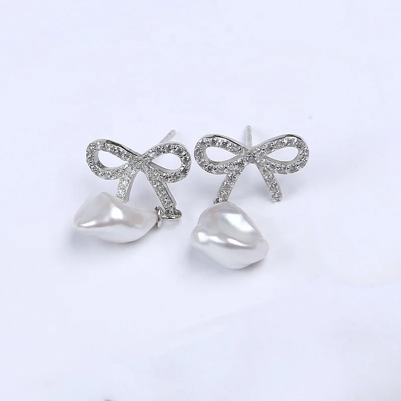 

10mm natural freshwater keshi pearl bowknot micro paved earrings, White