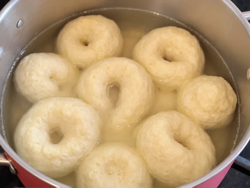 Bagels simmering in baking soda solution