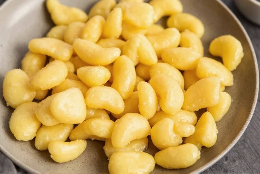 Homemade candied ginger pieces arranged on a wooden board
