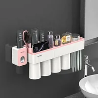 

Amazon New Design Wall Mount Plastic Auto Squeezing Toothpaste Dispenser with Toothbrush Holder and Magnetic Tumbler Cups