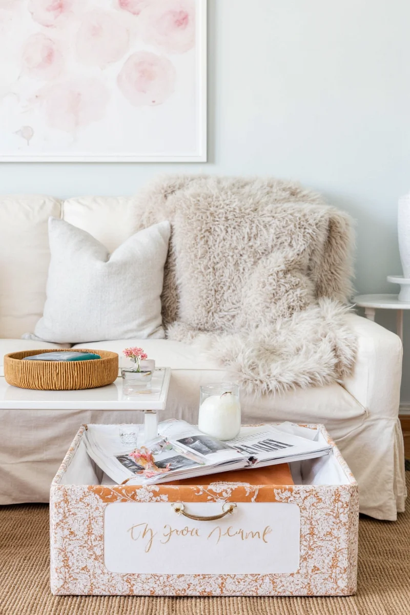 Legacy box styled on a living room coffee table with family photos