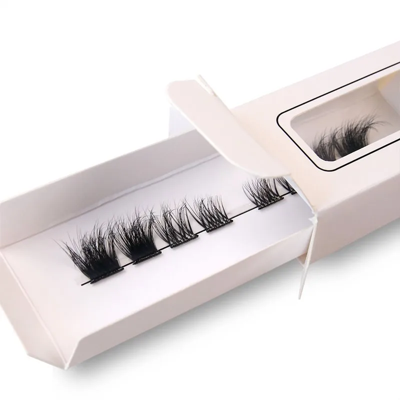 White lash box with a window top panel outlined by a thin printed rule, showing one row of clusters on a paper tray, being opened with the tray sliding out - window lash box