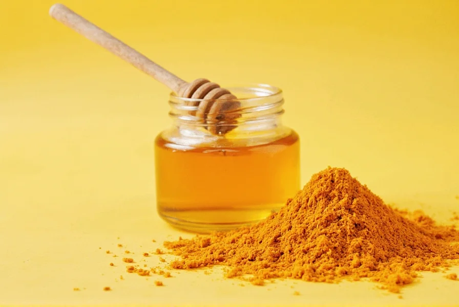 Golden milk preparation showing turmeric, honey, and black pepper in a glass