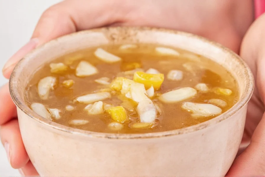 A supermarket shelf lined with various brands of chicken stock and broth