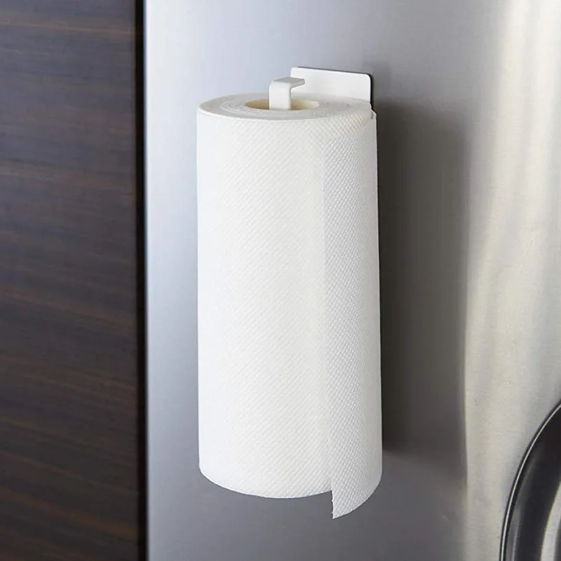 

One hand tears the magnetic refrigerator roll holder of the kitchen magnetic paper towel holder