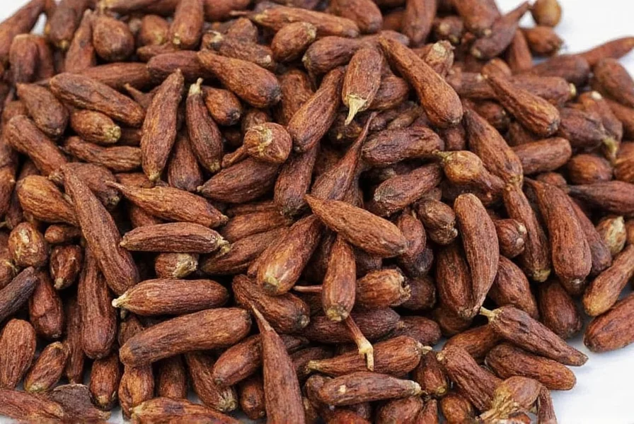 Fresh cloves still attached to stem showing their vibrant pink color