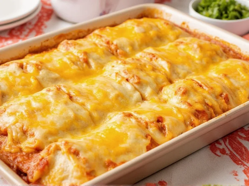 Rolling chicken enchiladas with cheese and sauce in baking dish