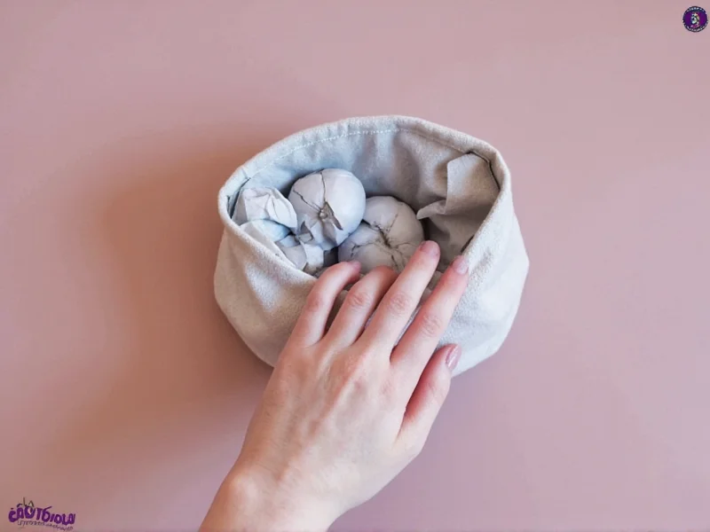 DIY cat toy made from crumpled paper balls in fabric pouch