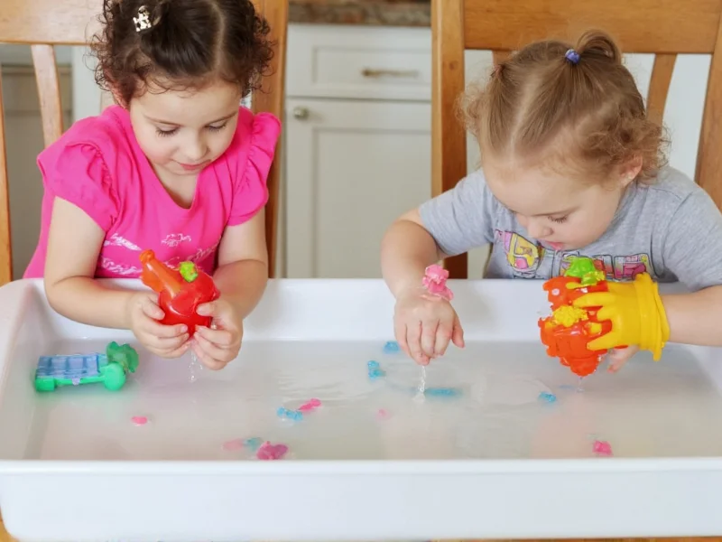Children playing sensory water activities with droppers and toys