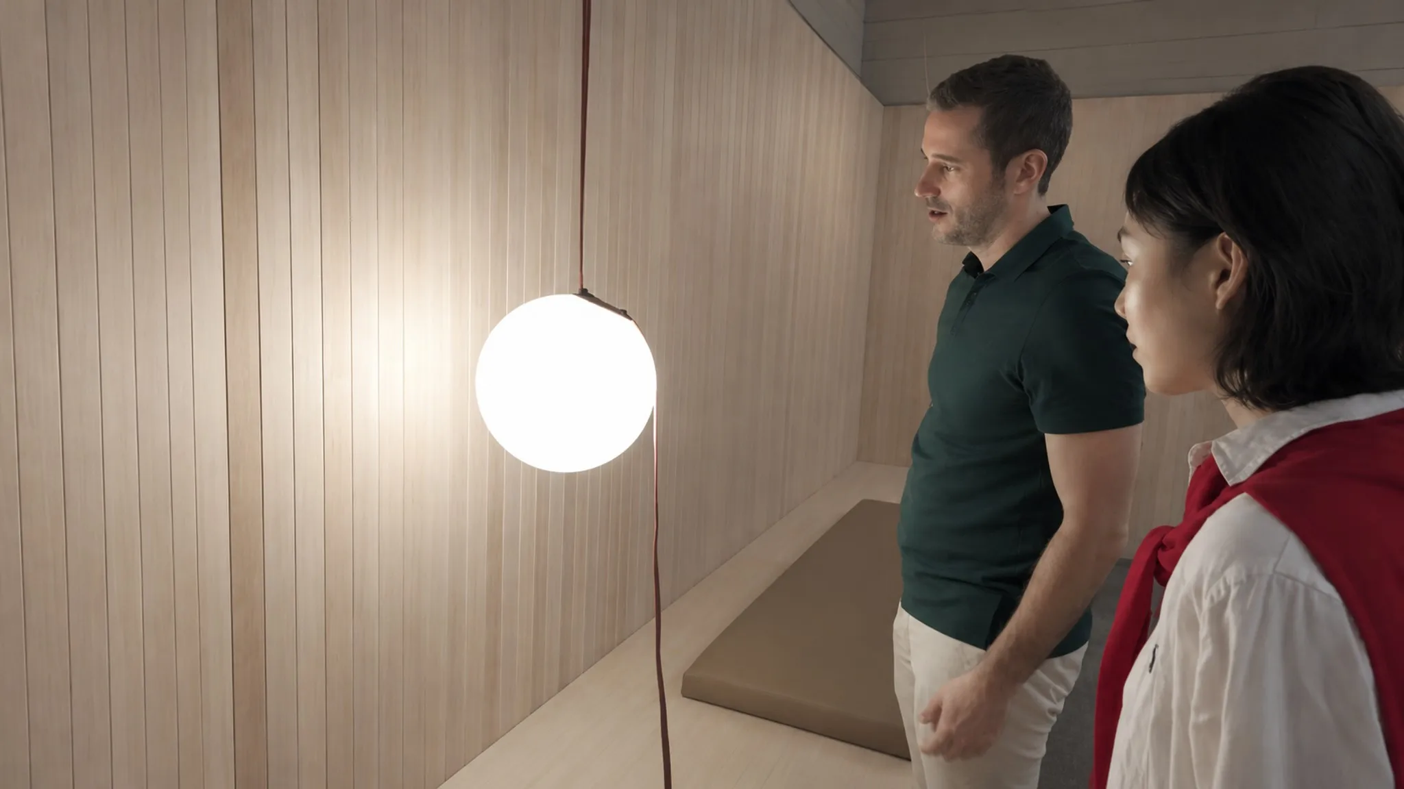Reviewing a pendant fixture in VIBIA's lighting display area