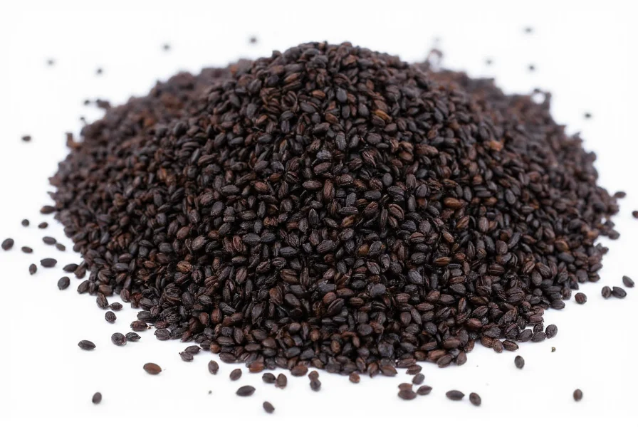 Black cumin oil bottle with measuring dropper on wooden background