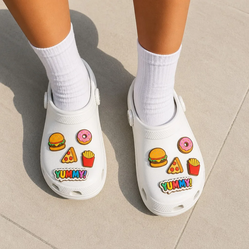 Food themed clog charms worn on foot with white socks on a sunlit pavement