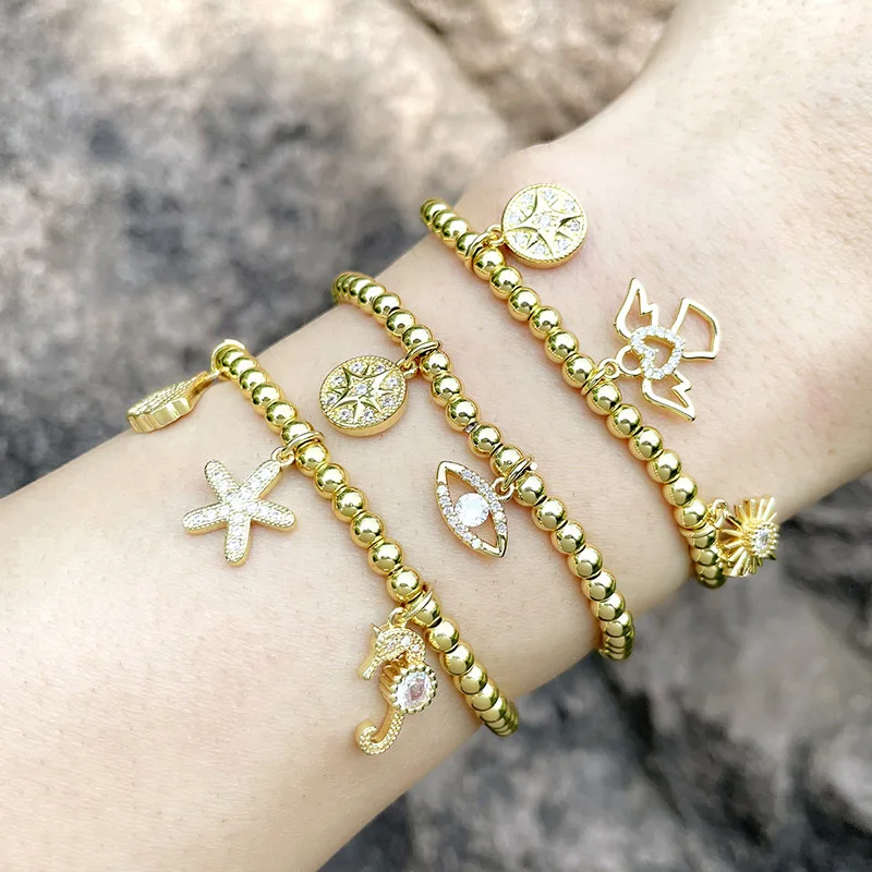 

2021 Newest 18k Gold Plated Stretch Bead CZ Sea Starfish Shell Bracelet Paved Crystal Star Sun Eyes Charm Bracelet For Women