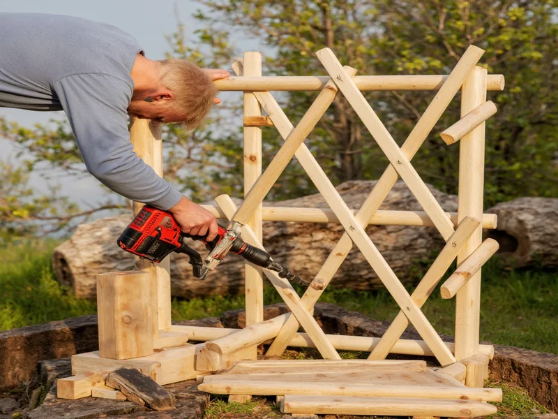 Assembling trellis frame with drill and wood pieces