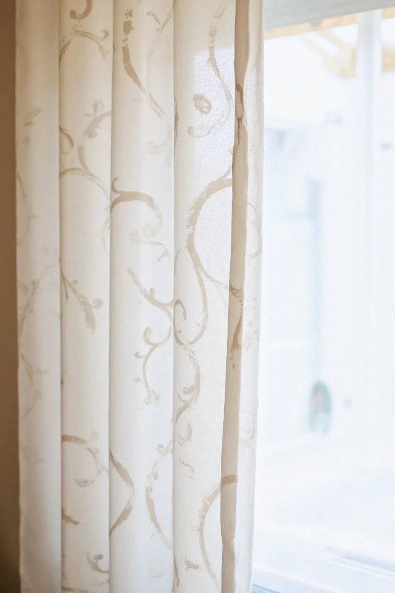 Ceiling tension system with draped curtains