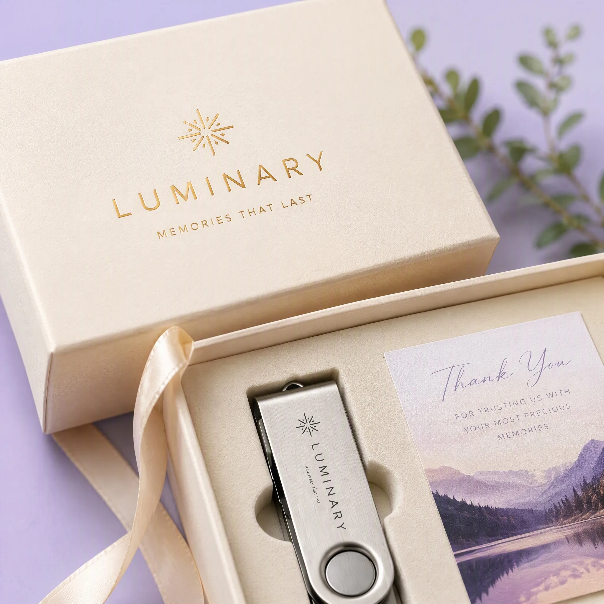 High-Angle Detailed Capture of Gold Foil Hot Stamped Logo on Ivory Gift Box Lid and Satin Ribbon