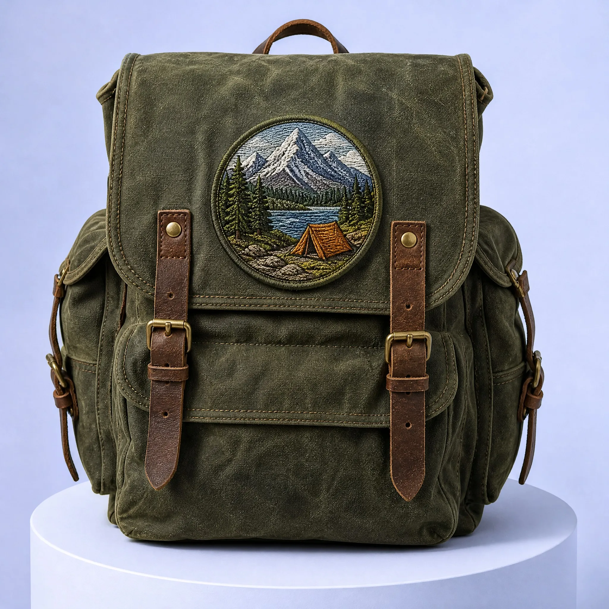 Vintage Olive Green Waxed Canvas Rucksack Backpack with Circular Mountain Lake Campfire Tent Embroidered Patch Mounted on Top Flap