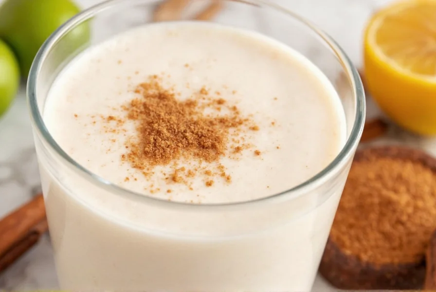 Homemade rice milk being poured into a glass with cinnamon sticks and ground cinnamon