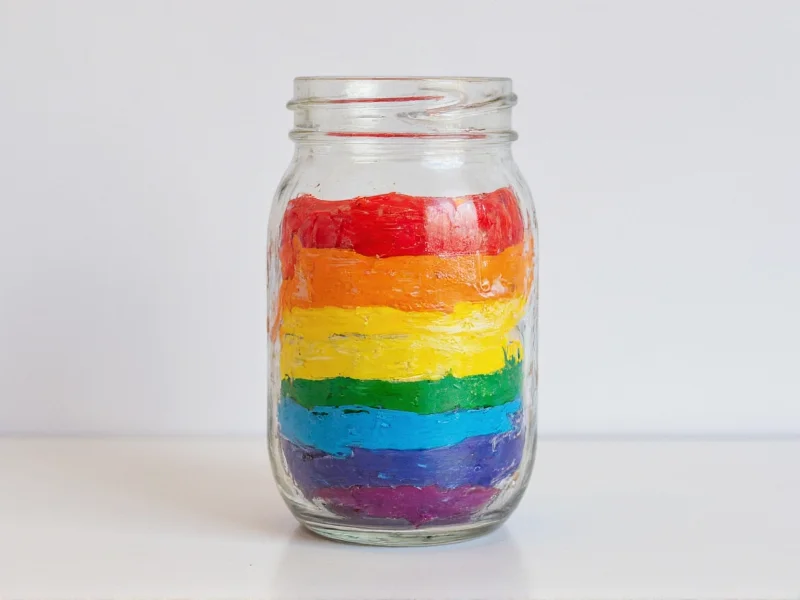 Hand-painted glass jar with acrylic craft paint showing vibrant colors