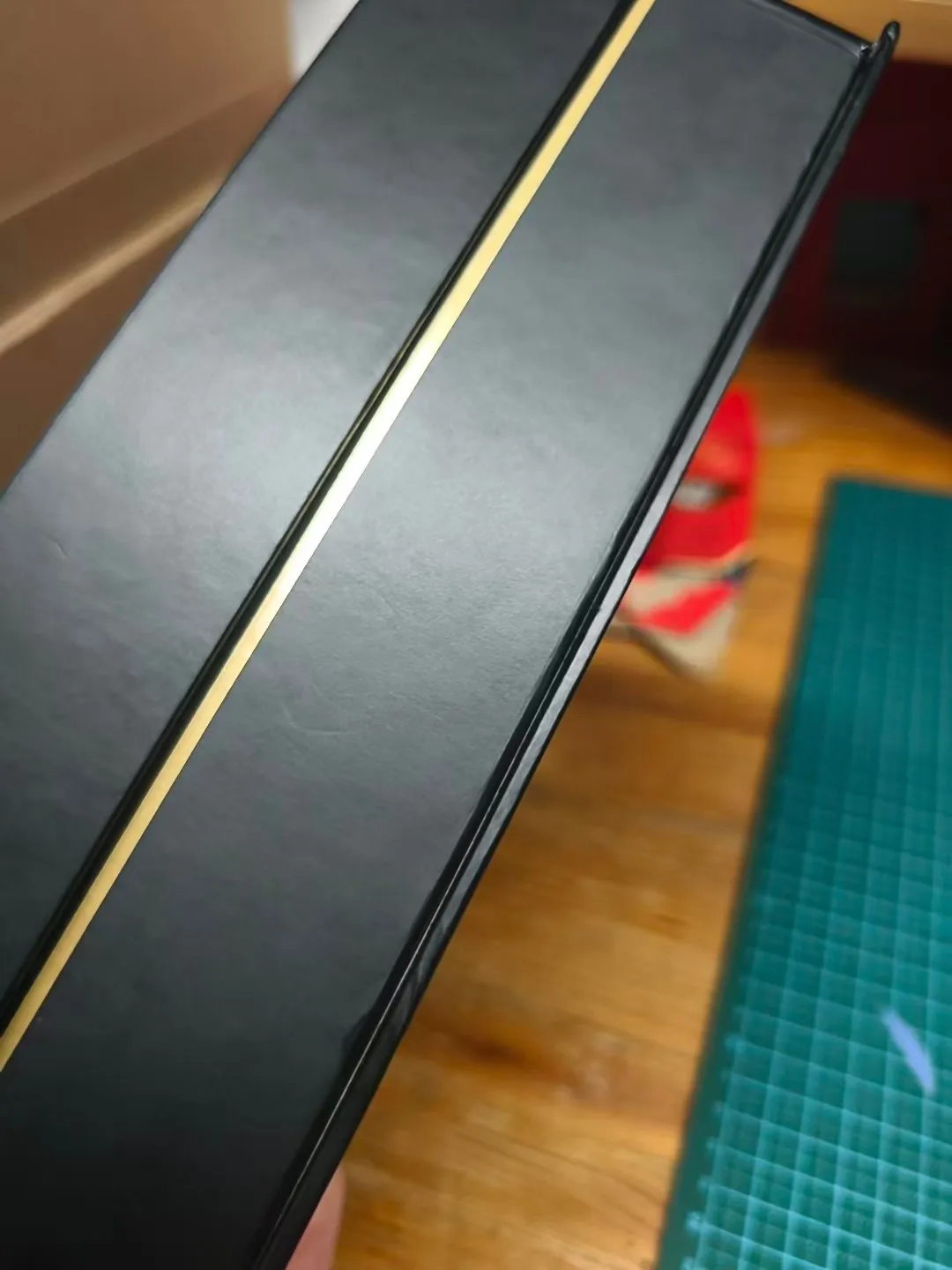 Visible seam gap defect on rigid box — poor gluing leaves corners open