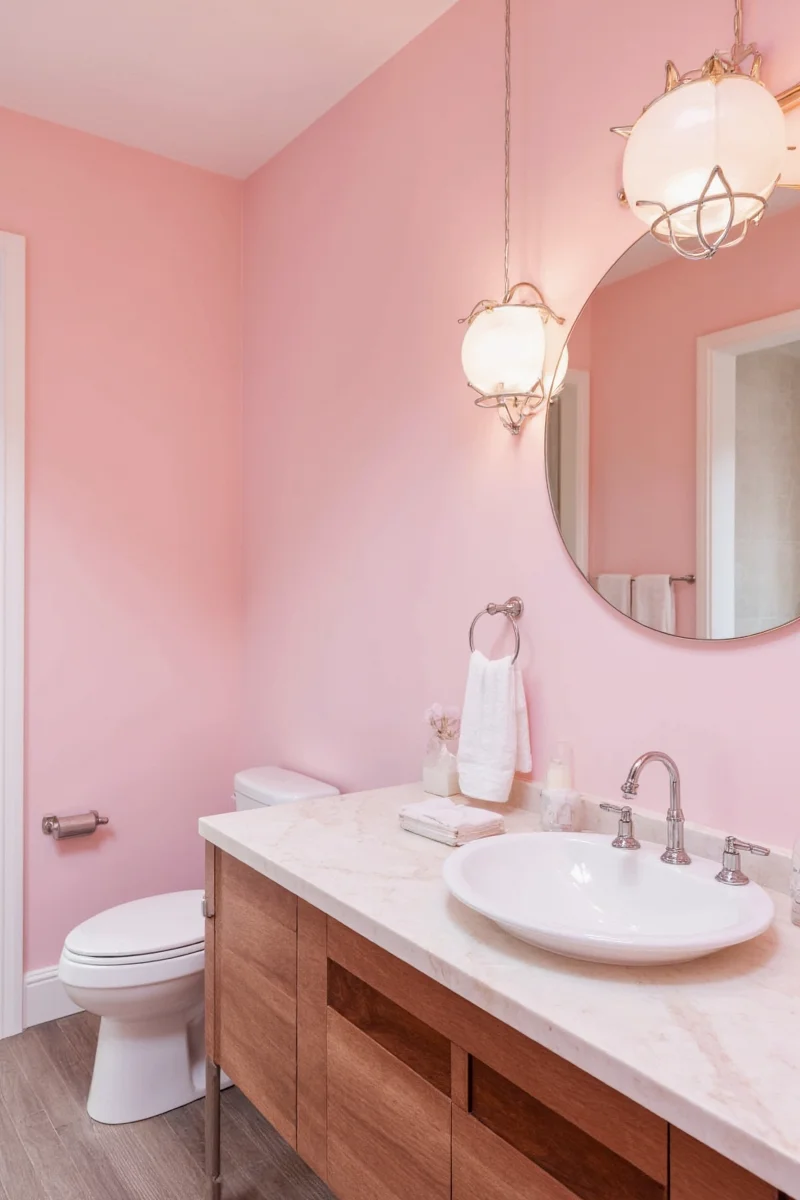 Modern pink bathroom with marble and brass fixtures