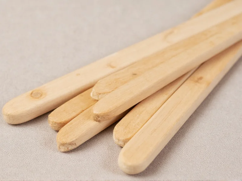 Close-up of natural wood craft sticks on fabric