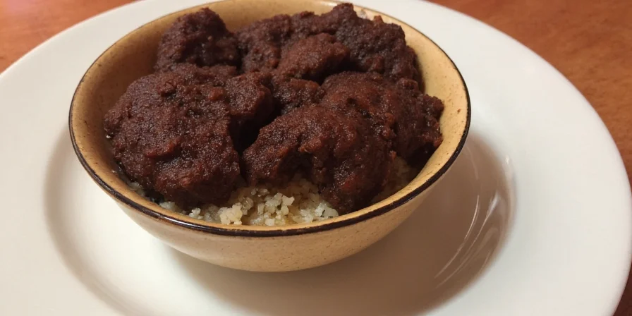 Mole sauce poured over enchiladas