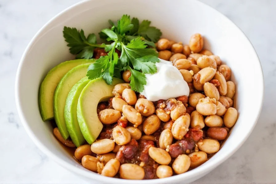Finished white bean chili with chicken served in a bowl with toppings including avocado, cilantro, and Greek yogurt