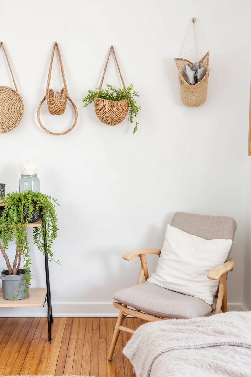 A modern kitchen with seagrass baskets under open shelving