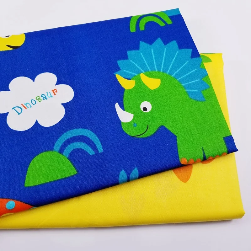 Azul dinosaurio de dibujos animados de algodón tela impresa para los niños es tela de la hoja
